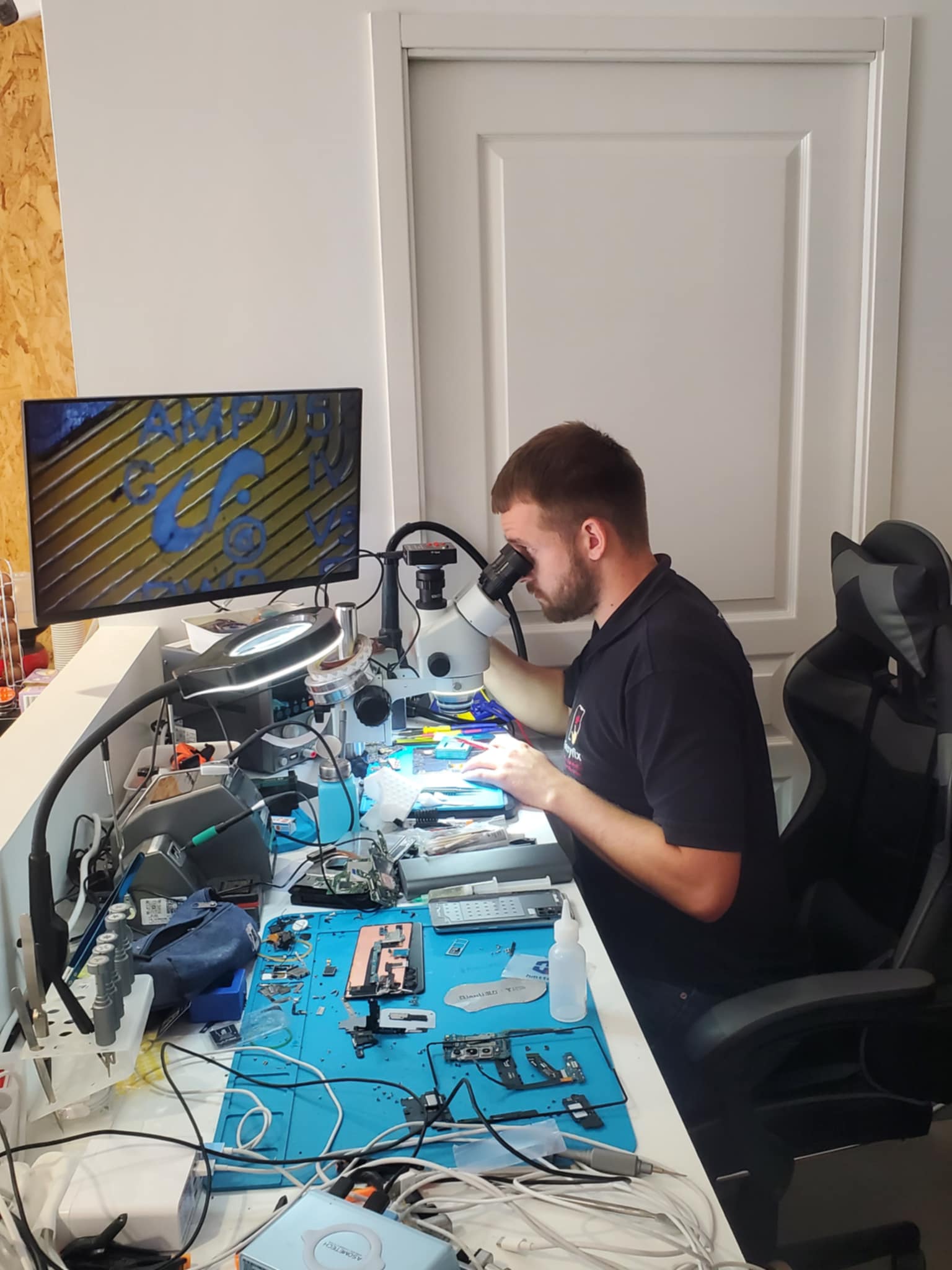 Technicien EasyFix effectuant une réparation par micro-soudure sous microscope